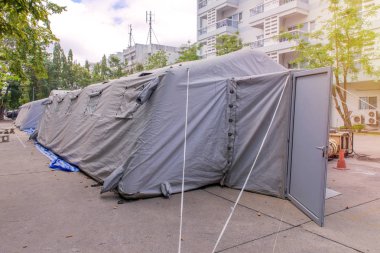 Military tent shelter on the street in town clipart