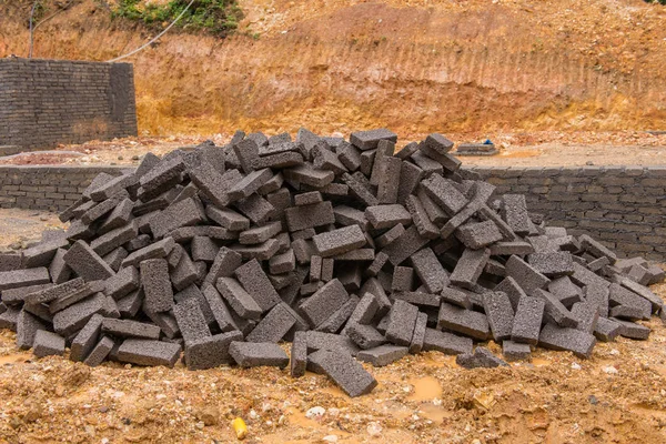 Black clay bricks for building at construction site — Stock Photo, Image