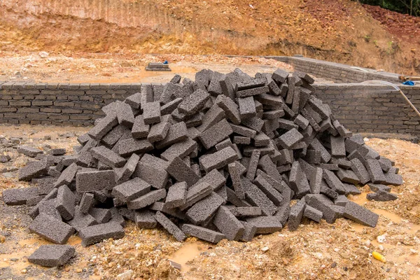 Black clay bricks for building at construction site — Stock Photo, Image