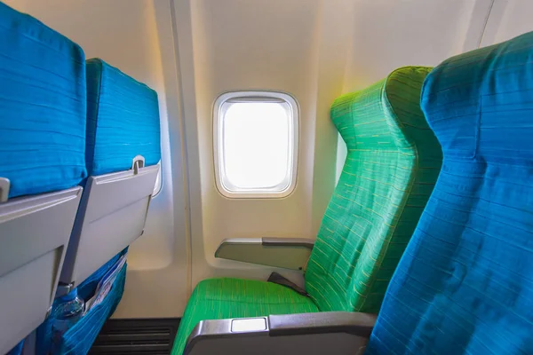 Airplane seat near windows in cabin of huge aircraft
