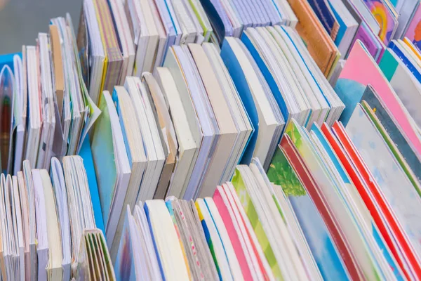 Muchos libros se apilan en la mesa de madera en la biblioteca —  Fotos de Stock