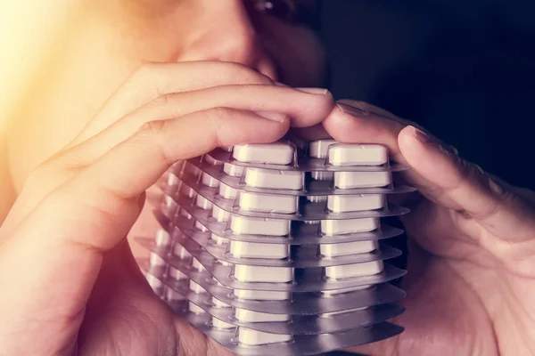 Patient's hand holding stack of many pills, drug abuse concept — Stock Photo, Image