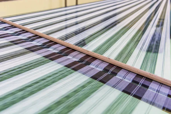 Weaving loom and shuttle on the warp — Stock Photo, Image