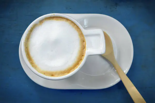 Xícara de café cappuccino em fundo de mesa de madeira — Fotografia de Stock