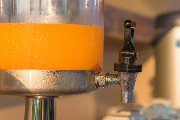 Orange juice in water cooler for breakfast at the hotel — Stock Photo, Image