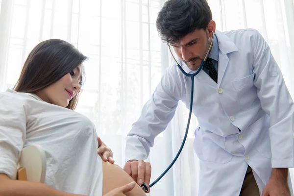 Medico misura la pressione di una donna incinta con stethoscop — Foto Stock