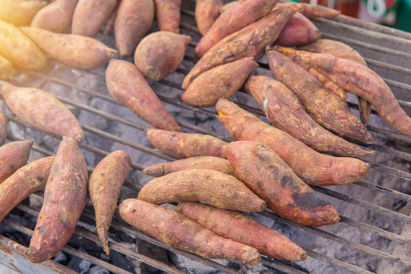 Brinnande yam eller sötpotatis på spis galler — Stockfoto