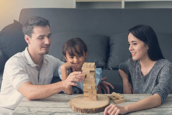 Szczęśliwa rodzina i córka gry klocki z drewna wieża w hom — Zdjęcie stockowe