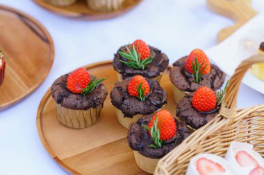 Beyaz masada taze çilekli çikolatalı kekler..