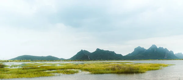 Beautiful landscape with a  calm evening landscape with lake and mountains in Prachubkeereekhan Thailand