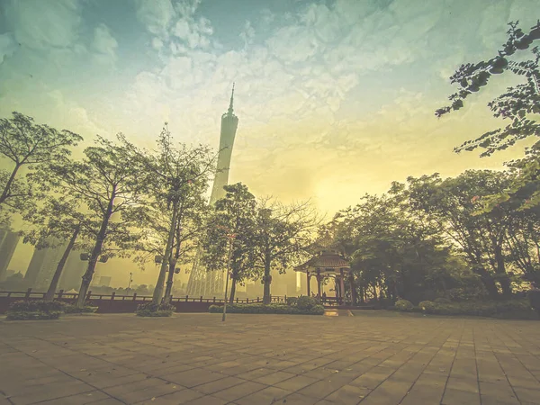 The Canton Tower formally Guangzhou TV Astronomical and Sightseeing. Viewed from the front entrance of Park with traditional Chinese Pavilion. New and old architecture in frame.