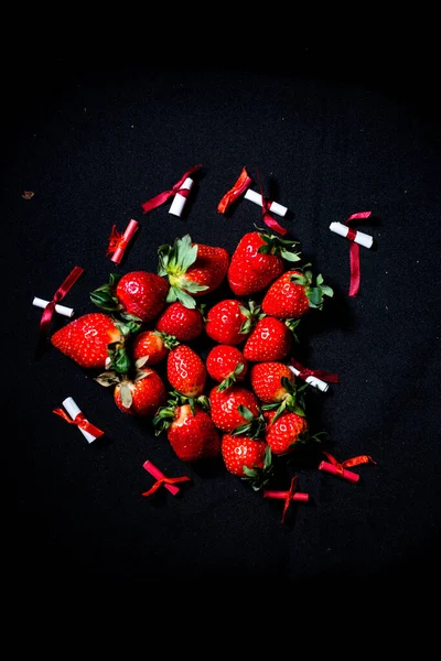 large strawberries on a black background