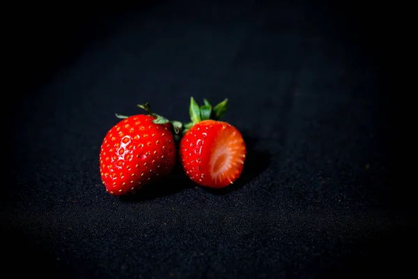 large strawberries on a black background