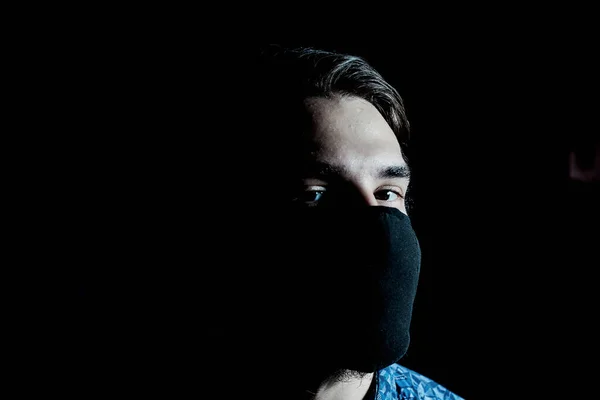 stock image masked guy in the gloom