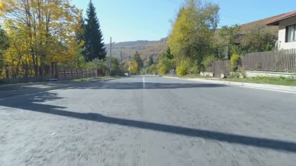 Drone following road unbroken white mid line markings on asphalt road — Stock Video