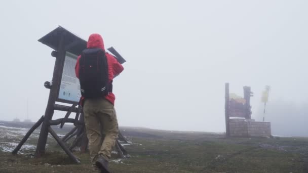 Touristen lesen Landkarte und suchen Schutz vor dem Regen — Stockvideo