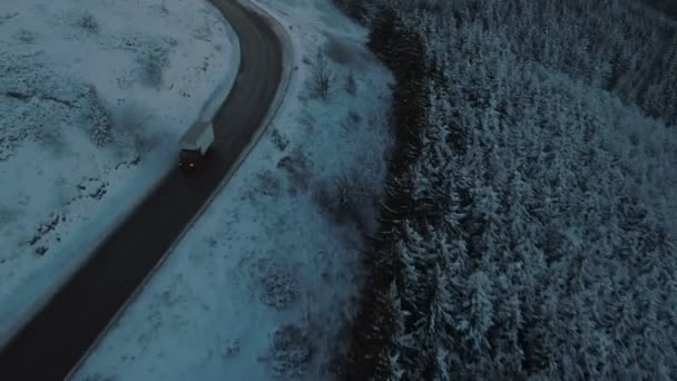 Transportbil kör långsamt på hal slingrande bergsväg under vintern — Stockvideo