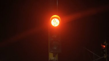 Changing red amber and green traffic light at night