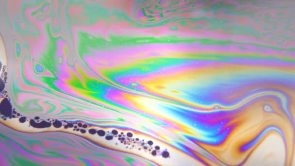 Dark colored bubbles moving in line, floating through rainbow liquid in pattern. Spirituality, hallucination concept — Stock Video