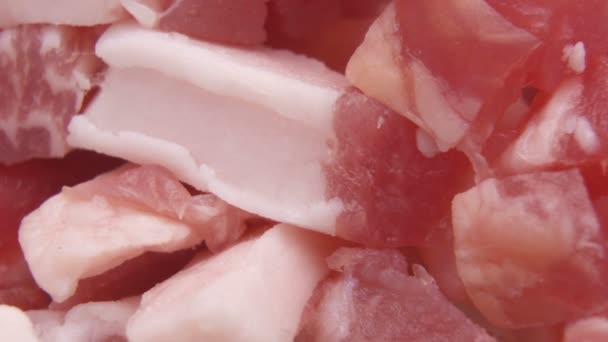 Raw fresh pork meat chunks on board, macro shot — Stock Video
