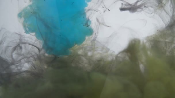 Abstract colorful swirl of ink droplets underwater — Stock Video