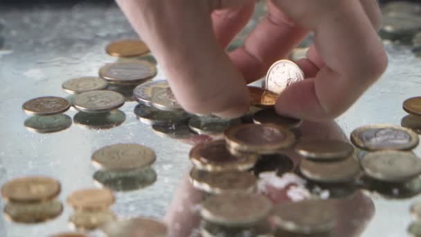 Treasure hunter hand picking coins from underwater — Stock Video