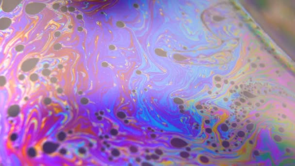 Фиолетовый и синий цвета жидкости течет, создавая пузырьки. Абстрактный фантастический фон — стоковое видео