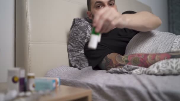 Hustender Mann nimmt seine Medikamente während der Quarantäne zu Hause ein — Stockvideo