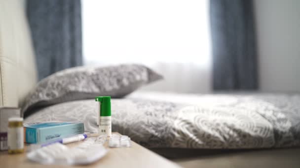 Medicine On Bedside Table. Multiple pills, capsules in blisters and spray in bedroom — Stock Video