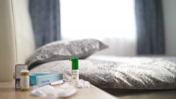 Bedroom with bed and nightstand with many medications and pills on top of it — Stock Video