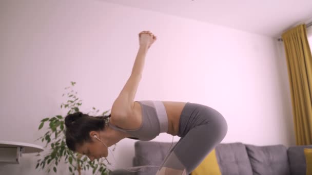 Beautiful fit woman doing cobra stretch at home on yoga man. Yoga Practice — Stock Video