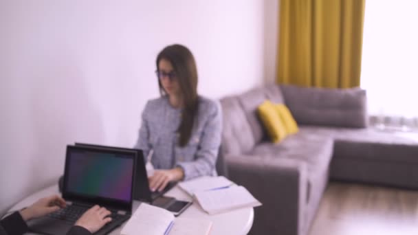 Twin sisters students elearning using laptops and taking notes with pen — Stock Video