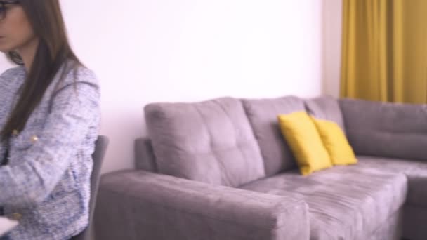 Young women sitting at the desk indoors in home office, working — Stock Video