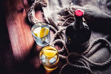 Bir şişe viski, ROM, brendi, bir ahşap zemin üzerine kireç