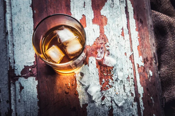 Whiskeyflasche und Glas auf einem hölzernen Vintage-Hintergrund — Stockfoto