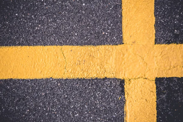 Yellow cross on the pavement — Stock Photo, Image