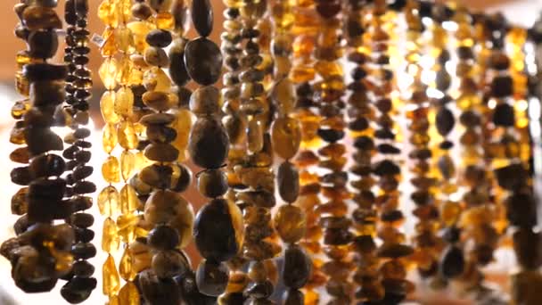 Articles made of amber close up.Womens beads. Womens necklaces. Womens jewelry — ストック動画