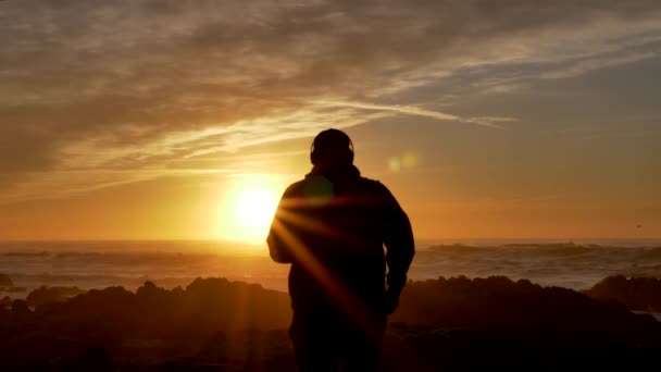 Αργή κίνηση σε άνδρες που τρέχουν το ηλιοβασίλεμα ή την ανατολή του ηλίου στις ακτές της Καλιφόρνια — Αρχείο Βίντεο