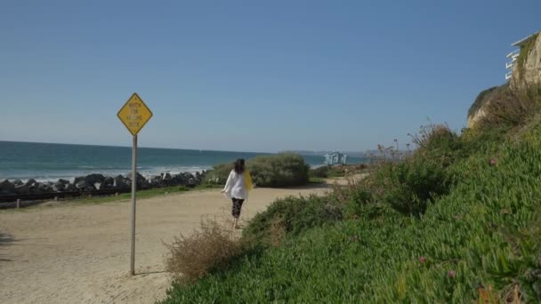 Donna anziana attiva a piedi sul sentiero pedonale vicino all'oceano con bellissimi paesaggi durante la giornata estiva in california san clemente spiaggia calafia. arancione contea stile di vita — Video Stock