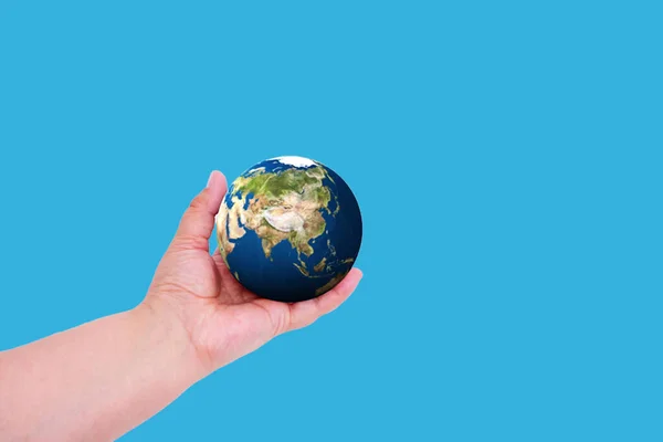 Planet earth in hand on a colored background with place for text. Earth day concept. Ecological problem — Stock Photo, Image