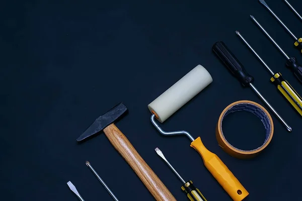 Flat lay various hand tools on a black background with copy space for text. Labor day background concept