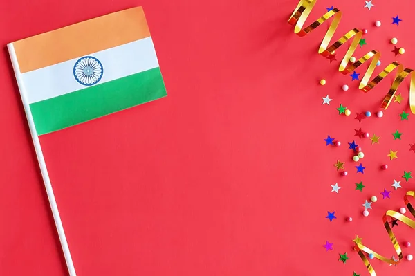 Indian Independence Day. Flag of India on a festive red background. The concept of celebration, patriotism and celebration. Copy space, flat lay.