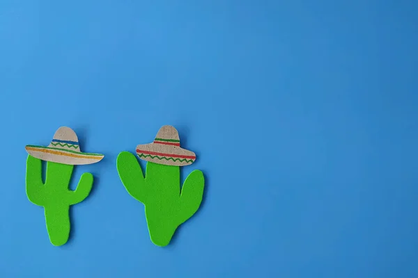 Cinco de Mayo with a Mexican cactus and a sombrero hat on a blue background. Fiesta, usa, mexican holiday.