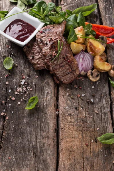 Beef steak on woode table — Stock Photo, Image