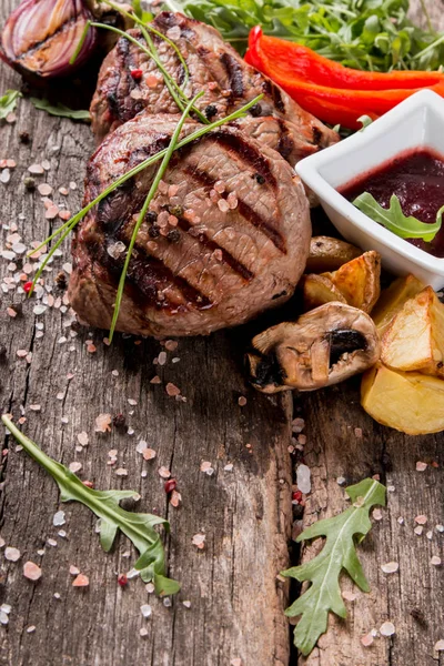 Beef steak on woode table — Stock Photo, Image