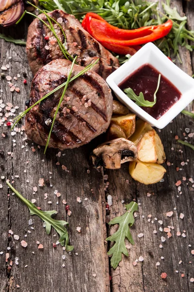 Beef steak on woode table — Stock Photo, Image