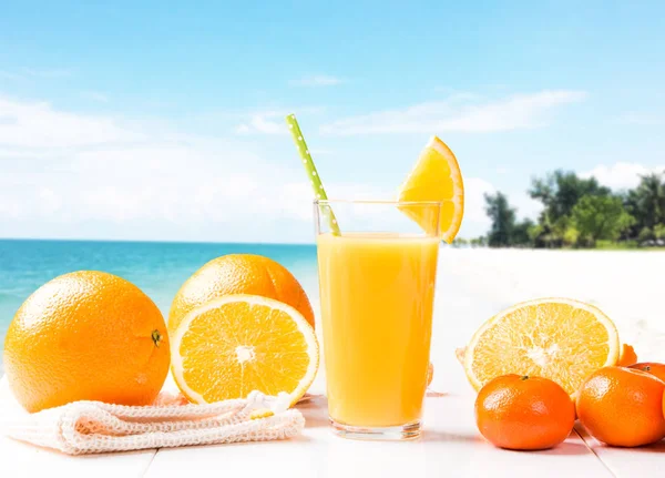 Fresh juice, orange drink with fresh fruits on wooden table.