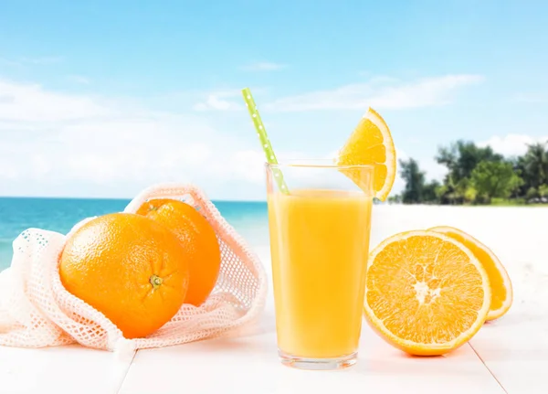 Fresh juice, orange drink with fresh fruits on wooden table.