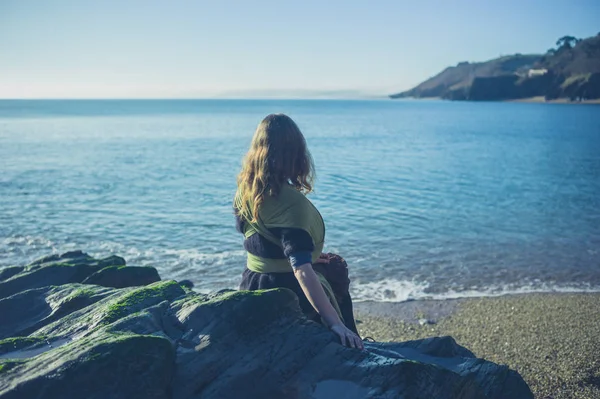 Eine Junge Frau Sitzt Auf Den Felsen Wasser — Stockfoto