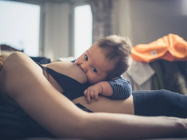 Bebê amamentando na cama — Fotografia de Stock